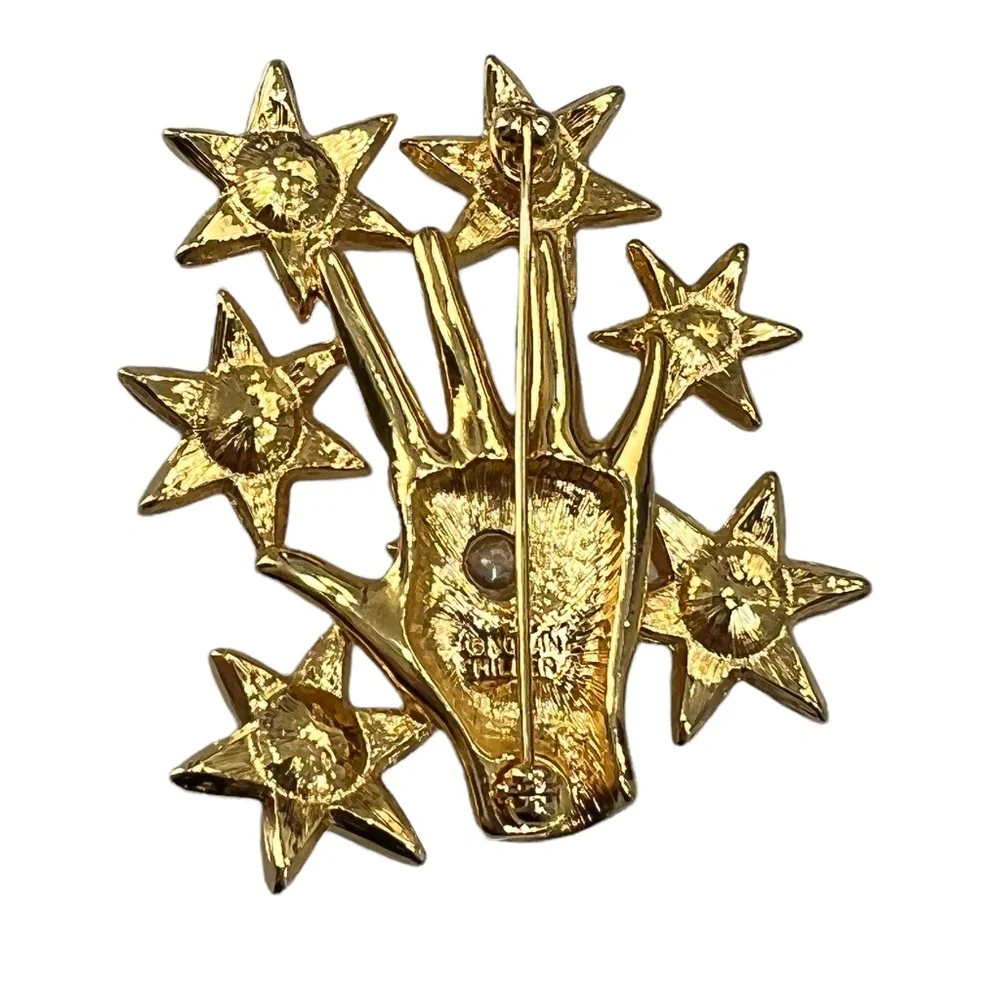 NOLAN MILLER SHINY GOLDEN HAND WITH CRYSTAL STARS BROOCH